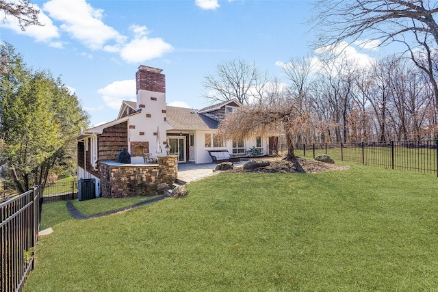 rear view of property with a yard, central air condition unit, a patio area, and a fenced backyard