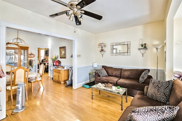 living room featuring light wood finished floors and a ceiling fan