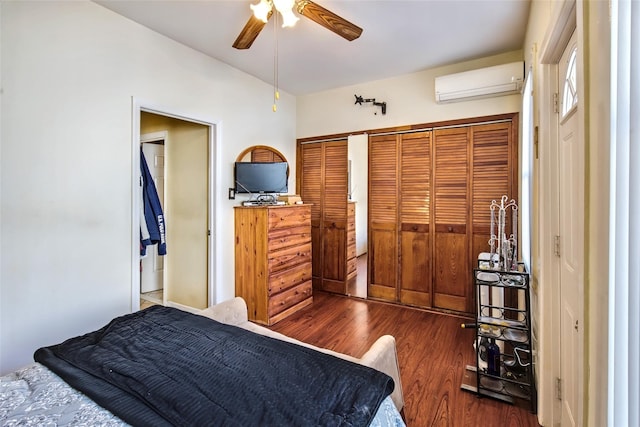 bedroom featuring dark wood-style floors, ceiling fan, a wall mounted AC, and a closet