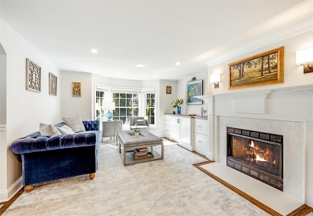 living room featuring recessed lighting, baseboards, and a tiled fireplace