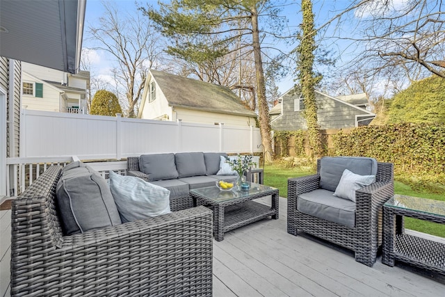 wooden deck with outdoor lounge area and a fenced backyard