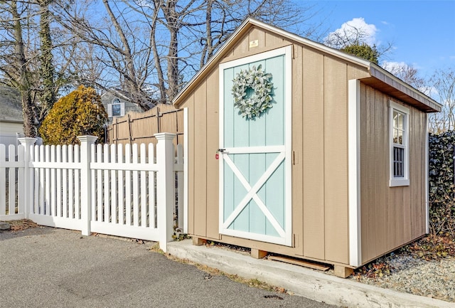 view of shed with fence