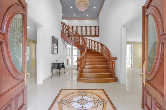 foyer entrance featuring french doors, stairway, recessed lighting, and crown molding