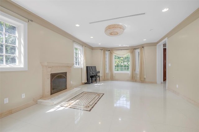 unfurnished living room with recessed lighting, crown molding, baseboards, and a premium fireplace