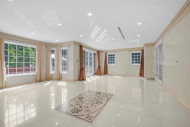 unfurnished living room with ornamental molding, light tile patterned flooring, and baseboards