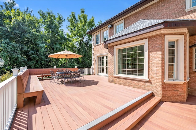 wooden terrace with outdoor dining space