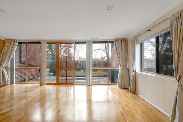 interior space featuring baseboards and wood finished floors