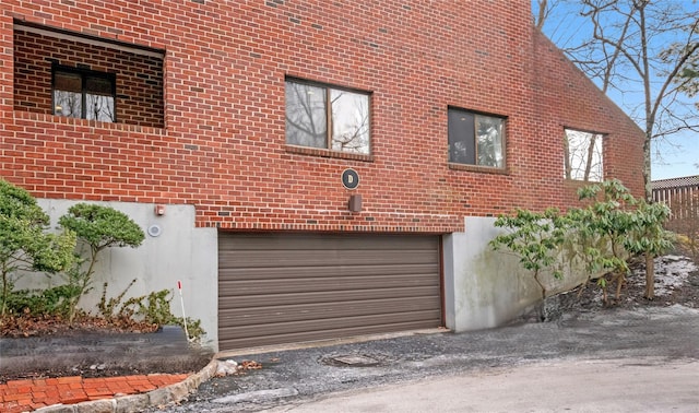 view of home's exterior featuring a garage and brick siding