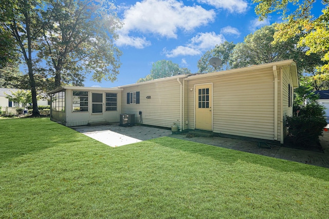 back of property featuring central AC unit, a lawn, and a patio area