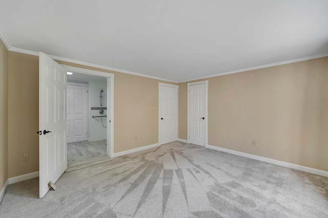 unfurnished bedroom with crown molding, light colored carpet, and baseboards