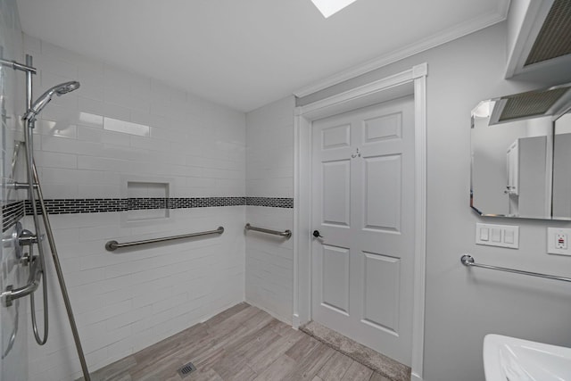 full bathroom with ornamental molding, a stall shower, and wood finished floors