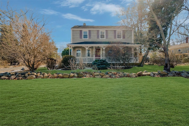 view of front of property with covered porch and a front yard