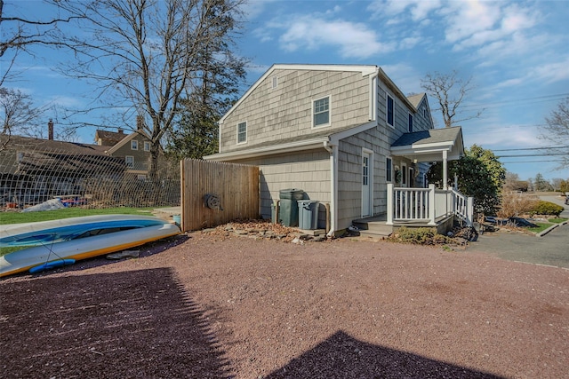 view of side of home featuring fence