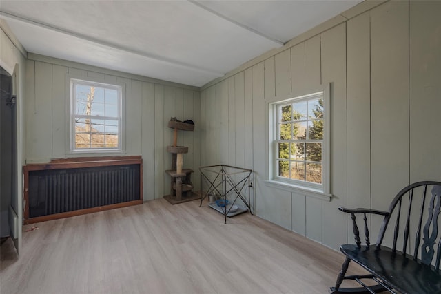 unfurnished room featuring light wood finished floors and radiator