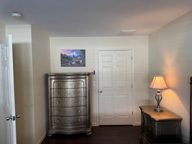 bedroom featuring visible vents, baseboards, and dark wood finished floors