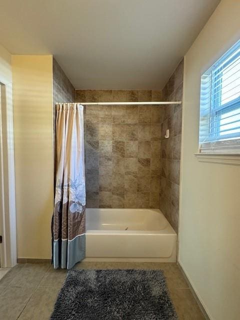 full bath featuring shower / bath combination with curtain, baseboards, and tile patterned floors