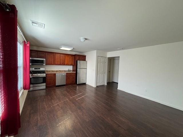 kitchen with dark wood-style floors, light countertops, visible vents, appliances with stainless steel finishes, and open floor plan