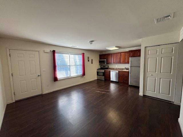 kitchen with visible vents, baseboards, dark wood-style floors, appliances with stainless steel finishes, and light countertops