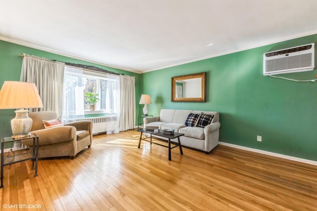 living room featuring baseboards, an AC wall unit, light wood-type flooring, radiator, and crown molding