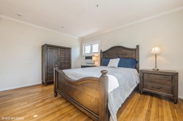 bedroom with light wood finished floors, baseboards, and crown molding