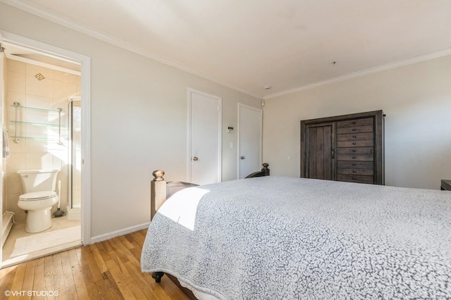 bedroom featuring crown molding, light wood-style flooring, and baseboards