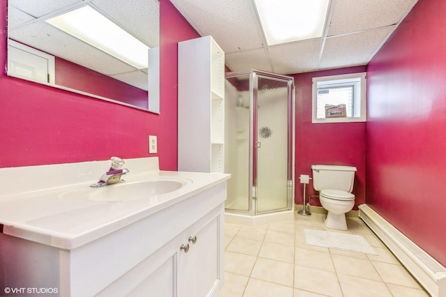 bathroom featuring a baseboard radiator, a drop ceiling, a shower stall, and toilet