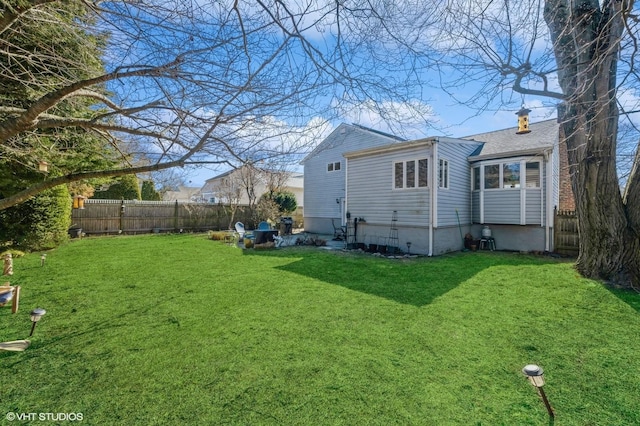 back of house with a yard and fence