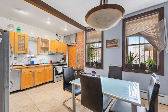 kitchen with under cabinet range hood, stainless steel appliances, light countertops, beam ceiling, and glass insert cabinets