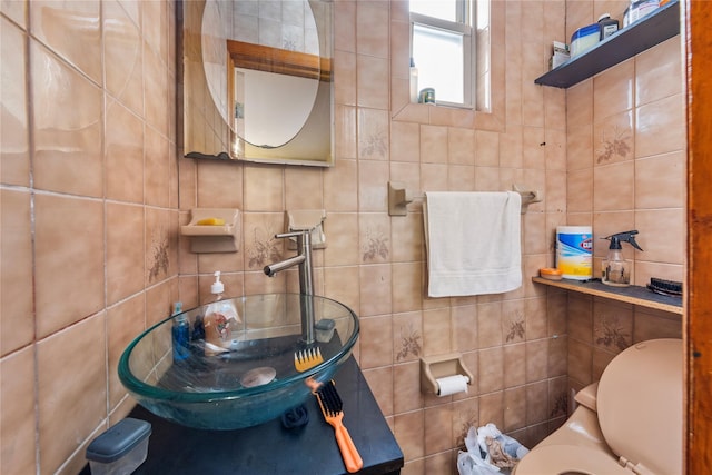 bathroom featuring tile walls and a sink