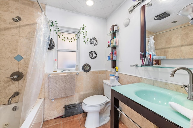 bathroom with tile walls, toilet, shower / bath combo, vanity, and tile patterned floors