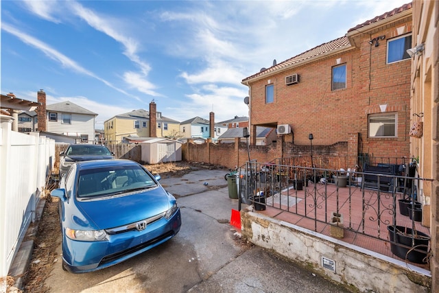 view of yard with a storage unit, an outdoor structure, fence private yard, and a residential view