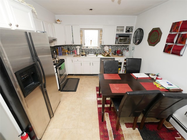 kitchen featuring backsplash, white cabinetry, stainless steel appliances, and light countertops