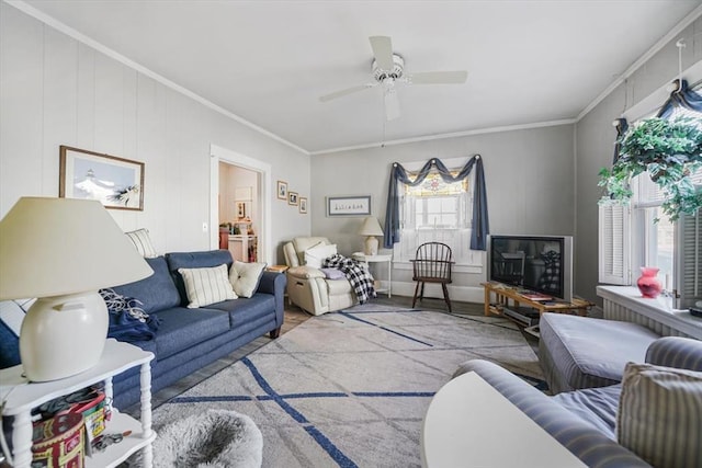 living room with ornamental molding and a ceiling fan