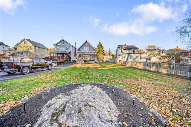 view of yard with a residential view and fence