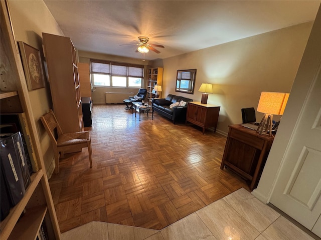 office area with ceiling fan and baseboards