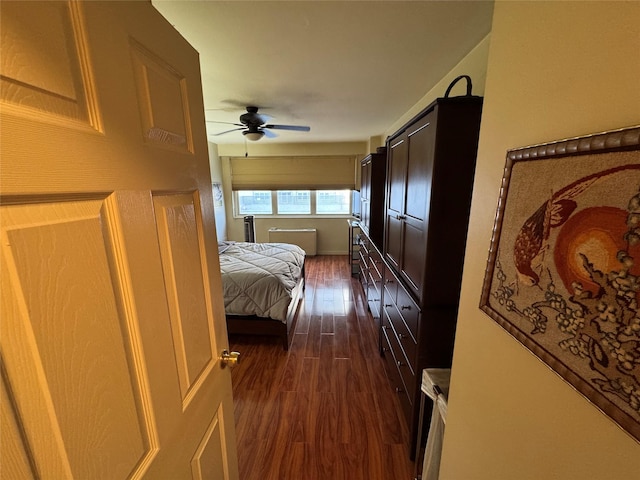 corridor featuring dark wood-style flooring