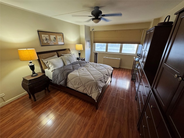 bedroom with dark wood-style flooring, ceiling fan, and baseboards