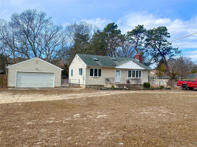 ranch-style house featuring a garage, an outbuilding, and a chimney