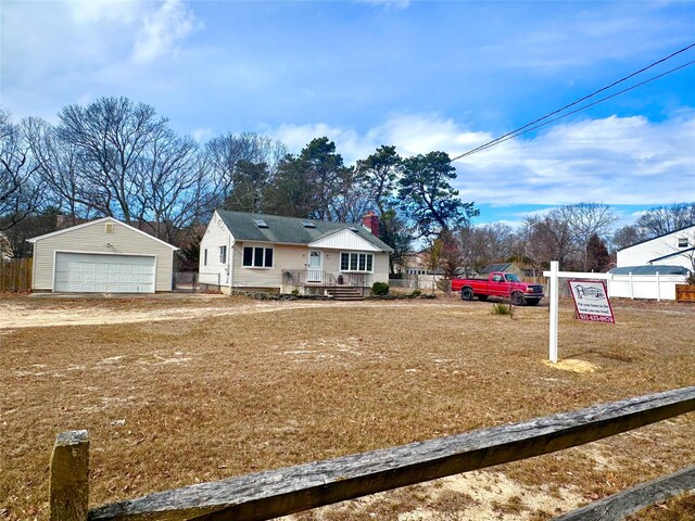 view of front of house with an outbuilding, fence, and a garage