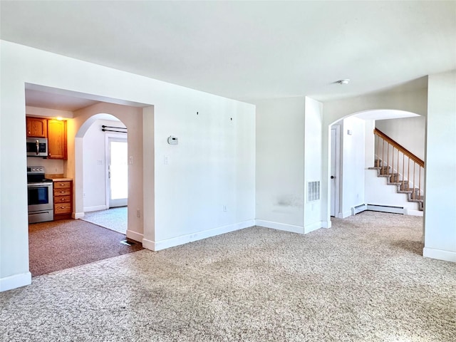 empty room with arched walkways, baseboard heating, light carpet, baseboards, and stairs