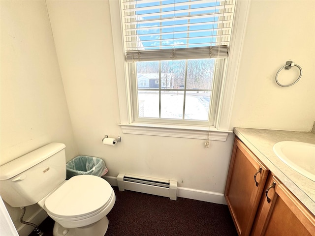 bathroom featuring baseboards, toilet, vanity, and baseboard heating