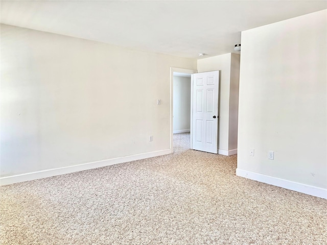 unfurnished room with baseboards and carpet flooring