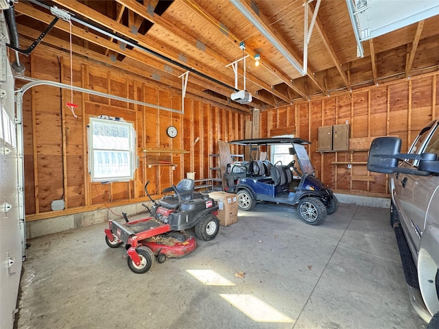 garage with electric panel and a garage door opener