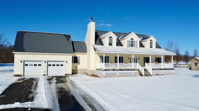 cape cod home featuring a garage, driveway, a chimney, and a porch