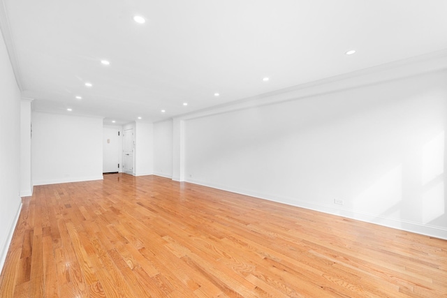 unfurnished living room featuring recessed lighting, light wood-style flooring, and baseboards