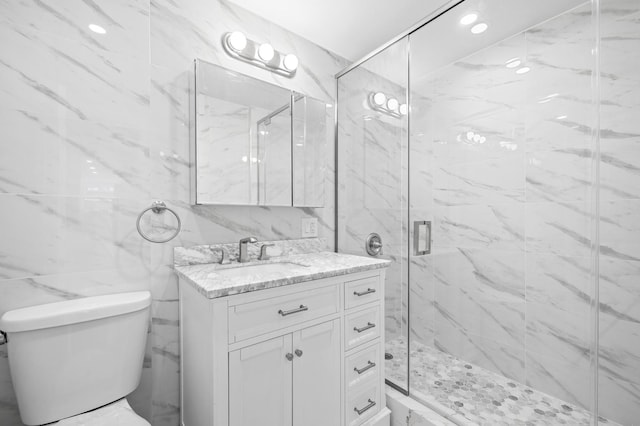 full bathroom with toilet, a marble finish shower, vanity, and tile walls