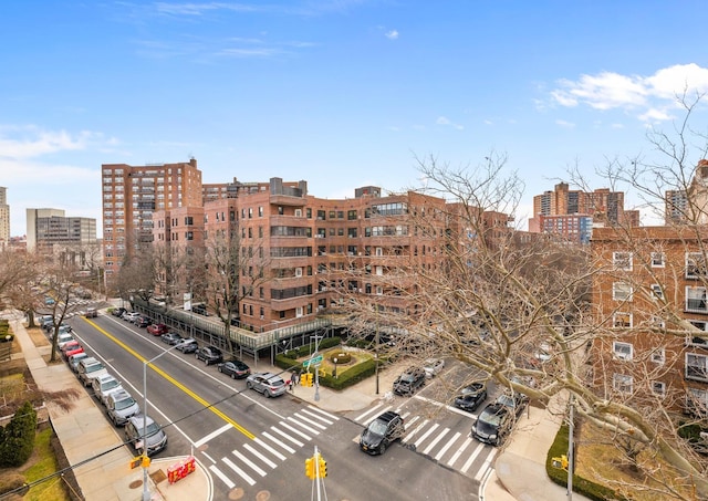 view of building exterior featuring a view of city and uncovered parking