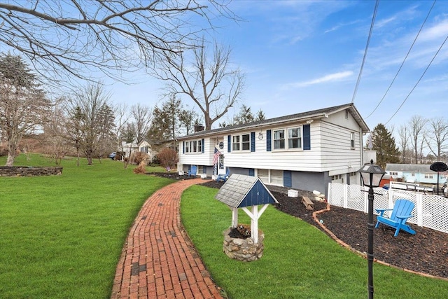 view of front of property featuring a front lawn, a chimney, and fence