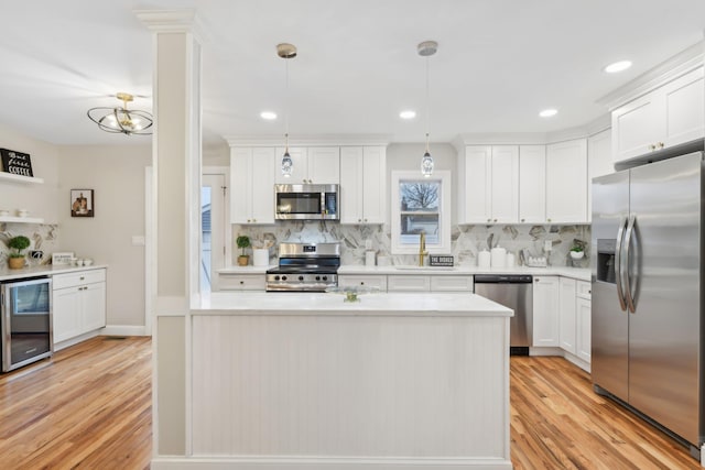 kitchen with backsplash, beverage cooler, stainless steel appliances, and light countertops