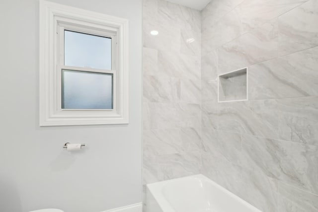 bathroom featuring  shower combination and baseboards